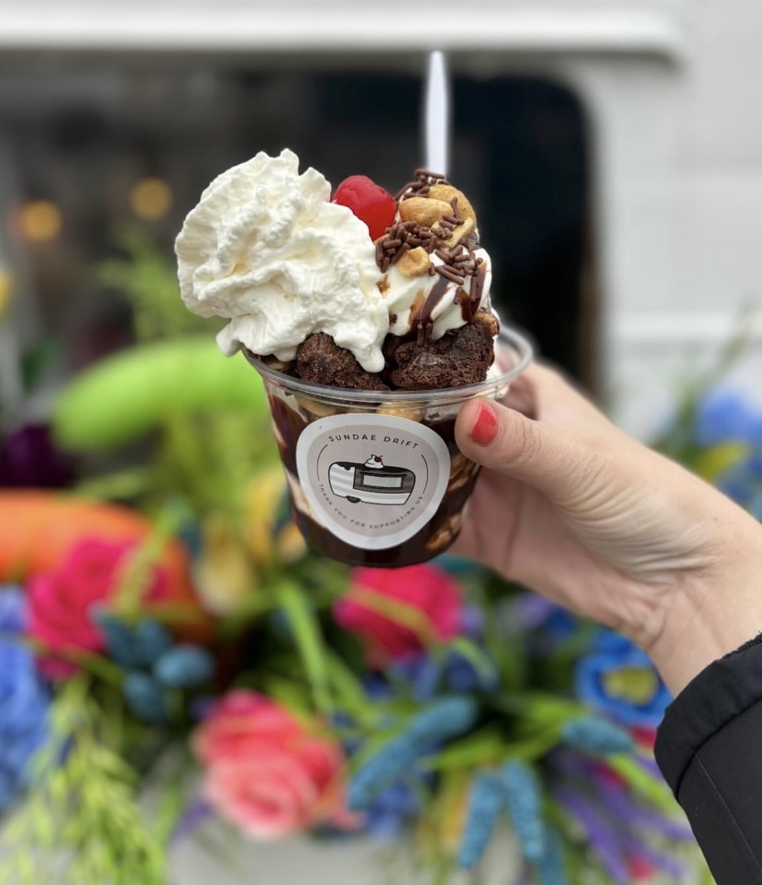 woman holding an ice cream sundae