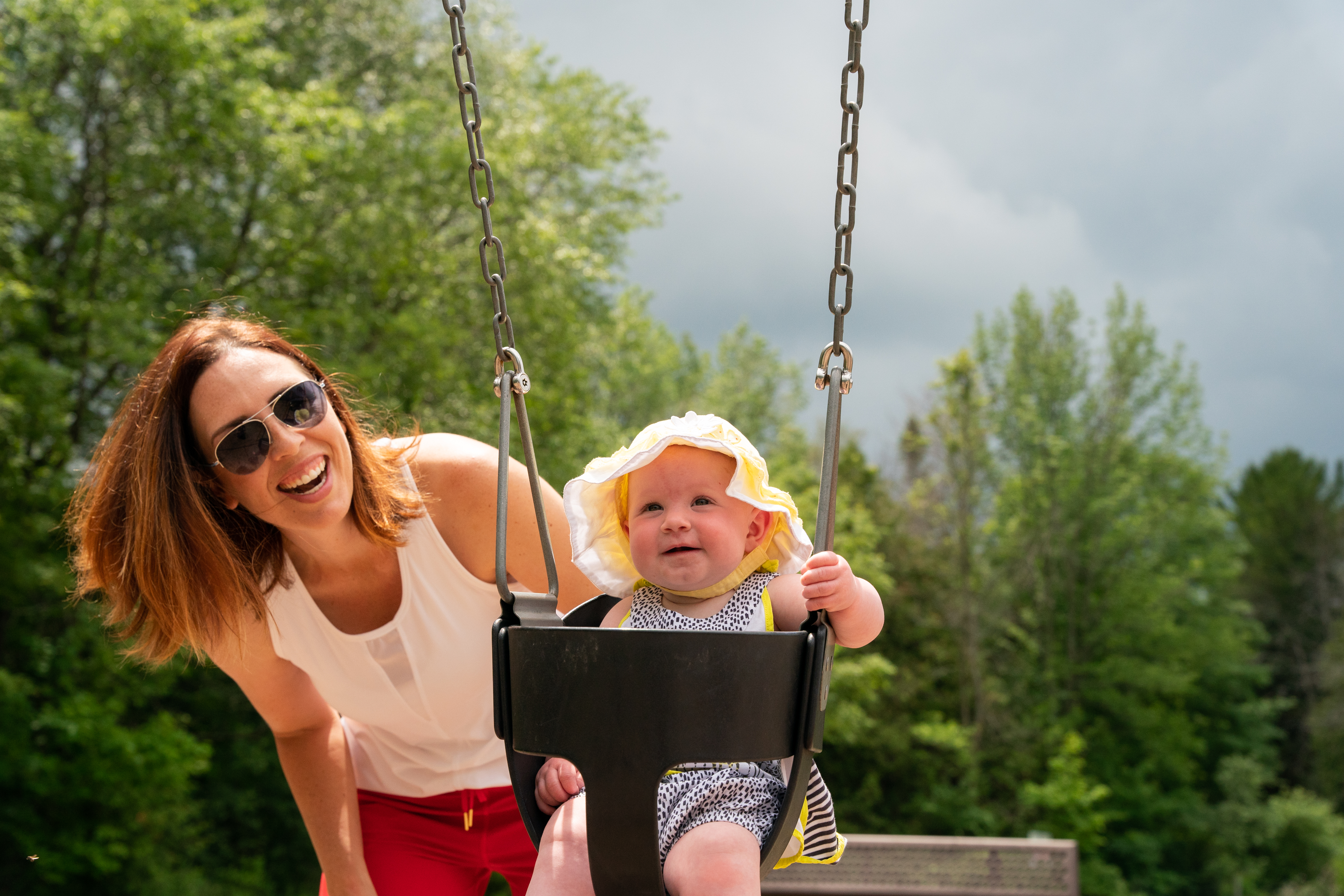 Mom pushing baby in a swing